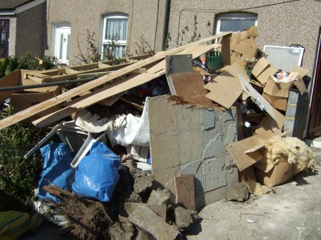 Professional garage clearance team working in a Bow garage